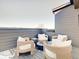 Inviting rooftop deck featuring stylish wicker furniture and a cozy fire pit, perfect for outdoor relaxation at 1208 N Alabama St, Indianapolis, IN 46202