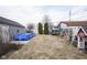 Spacious backyard featuring an above-ground pool, trampoline, swing set, and mature trees at 1208 W 8Th St, Anderson, IN 46016