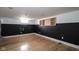A partially-finished basement with light wood flooring and a chalk wall at 1208 W 8Th St, Anderson, IN 46016