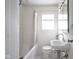 Bright bathroom featuring white tile, classic fixtures and a shower-tub combination at 1208 W 8Th St, Anderson, IN 46016