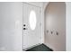 Bright entryway featuring a white door with an oval window and coat hooks at 1208 W 8Th St, Anderson, IN 46016
