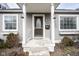 Inviting front entry with a classic door and a covered porch with decorative lighting at 1208 W 8Th St, Anderson, IN 46016