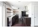Stylish kitchen featuring stainless steel appliances, white subway tile, and dark cabinetry at 1208 W 8Th St, Anderson, IN 46016