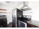 Modern kitchen featuring stainless steel appliances and dark cabinetry at 1208 W 8Th St, Anderson, IN 46016