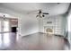 Bright living room with hardwood floors, white fireplace, and open access to the kitchen at 1208 W 8Th St, Anderson, IN 46016