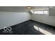 Finished attic space with gray carpeted floors, white walls and a window at 1342 W 18Th St, Indianapolis, IN 46202