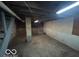 Unfinished basement with exposed ceiling and concrete floor is ready for your updates at 1342 W 18Th St, Indianapolis, IN 46202