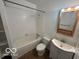 Bright bathroom with a shower-tub combo, vanity, and mirrored cabinet at 1342 W 18Th St, Indianapolis, IN 46202