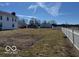 The large backyard of a two-story home is surrounded by a white picket fence at 13863 N Stiles Rd, Mooresville, IN 46158