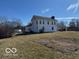 Sprawling white two-story home with a chimney and well-maintained lawn, set against a clear blue sky at 13863 N Stiles Rd, Mooresville, IN 46158