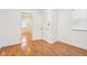 Bright bedroom features wood floors, white walls, and a doorway to another room at 1804 Spann Ave, Indianapolis, IN 46203