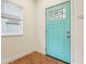 Bright entryway featuring beautiful wood floors and a modern turquoise door at 1804 Spann Ave, Indianapolis, IN 46203