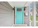 Close-up of a stylish turquoise front door with sidelights, enhancing curb appeal at 1804 Spann Ave, Indianapolis, IN 46203
