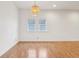 Bright living room featuring hardwood floors and a modern hanging light fixture at 1804 Spann Ave, Indianapolis, IN 46203