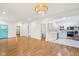 Open-concept living area with hardwood floors seamlessly connects to a modern white kitchen at 1804 Spann Ave, Indianapolis, IN 46203