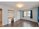 Spacious bedroom featuring star decorations, a built-in desk, a closet, and wide plank wood flooring at 2830 Moller Rd, Indianapolis, IN 46224
