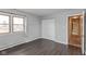 This bedroom features wood floors, a closet with sliding doors, and a window for ample natural light at 2830 Moller Rd, Indianapolis, IN 46224