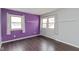 Modern bedroom featuring hardwood floors, a two-tone paint scheme, and natural light at 2830 Moller Rd, Speedway, IN 46224