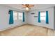 Spacious bedroom featuring a ceiling fan, two windows with curtains, and carpeted flooring at 2830 Moller Rd, Indianapolis, IN 46224