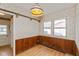 Charming breakfast nook with wood-paneled walls, laminate flooring, and floral wallpaper at 2830 Moller Rd, Indianapolis, IN 46224