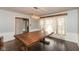 Bright dining room featuring a dark wood table, decorative light fixture and a large window at 2830 Moller Rd, Indianapolis, IN 46224