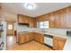 Well-lit kitchen with wood cabinets, laminate countertops, and modern appliances at 2830 Moller Rd, Indianapolis, IN 46224