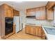 Efficient kitchen featuring wood cabinets, laminate counters, and clean, white appliances at 2830 Moller Rd, Indianapolis, IN 46224