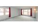 Spacious living room featuring large windows, neutral paint, and carpeted flooring at 2830 Moller Rd, Indianapolis, IN 46224