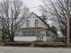This charming two-story house is set amongst mature trees and a landscaped yard with an enclosed porch at 290 S Marion St, Morgantown, IN 46160