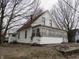 Two-story home with an enclosed porch and an attached structure on a spacious lot with mature trees at 290 S Marion St, Morgantown, IN 46160