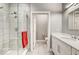 Bathroom features glass shower, vanity with white cabinets and hard surface countertop with access to toilet at 319 E 16Th E St # 201, Indianapolis, IN 46202
