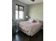 A cozy bedroom featuring warm lighting and a comfortable bed, plus a crib for a small  at 319 E 16Th E St # 201, Indianapolis, IN 46202