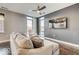 Comfortable living room featuring modern ceiling fan, dark hardwood floors, and large windows for natural light at 319 E 16Th E St # 201, Indianapolis, IN 46202