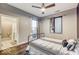 Main bedroom with hardwood floors, modern ceiling fan, exterior access, and attached bathroom at 319 E 16Th E St # 201, Indianapolis, IN 46202