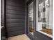 Apartment balcony with wood floor and black metal railings with sliding glass door to kitchen at 319 E 16Th St # 302, Indianapolis, IN 46202