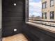 Apartment balcony with wood floor and black metal railings with view of surrounding buildings at 319 E 16Th St # 302, Indianapolis, IN 46202