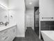 Modern bathroom showcasing sleek black tiled floors, glass enclosed shower and separate soaking tub at 319 E 16Th St # 302, Indianapolis, IN 46202