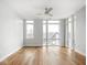 Spacious bedroom with hardwood floors, a modern ceiling fan and abundant natural light from multiple windows at 319 E 16Th St # 302, Indianapolis, IN 46202