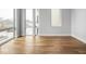 Sunlit bedroom featuring hardwood floors, clean lines, and several windows providing ample natural light at 319 E 16Th St # 302, Indianapolis, IN 46202