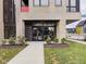 Building entrance with modern design, glass doors, and landscaping showcasing the building's clean lines and curb appeal at 319 E 16Th St # 302, Indianapolis, IN 46202