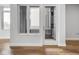 Bright entryway featuring hardwood floors, a modern window and a glass door leading to a private outdoor space at 319 E 16Th St # 302, Indianapolis, IN 46202