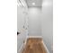 Bright hallway features wood floors, white trim and doors, offering a clean and modern aesthetic at 319 E 16Th St # 302, Indianapolis, IN 46202