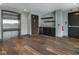 Hallway with wood floors, elevator, restroom door and kitchenette area at 319 E 16Th St # 302, Indianapolis, IN 46202