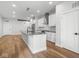 Open-concept kitchen featuring modern cabinets, stainless steel appliances, a large island, and hardwood floors at 319 E 16Th St # 302, Indianapolis, IN 46202