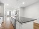 Modern kitchen island with sink, stainless steel appliances, and open layout at 319 E 16Th St # 302, Indianapolis, IN 46202