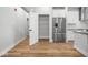 Kitchen with stainless steel refrigerator, white cabinets, and hardwood floors, creating a bright, modern space at 319 E 16Th St # 302, Indianapolis, IN 46202