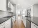 Contemporary kitchen with stainless steel appliances, white cabinets, and a modern backsplash at 319 E 16Th St # 302, Indianapolis, IN 46202