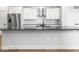 Close-up shot of a modern kitchen island with stainless steel appliances and subway tile backsplash at 319 E 16Th St # 302, Indianapolis, IN 46202