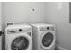 Laundry room featuring a white front-load washing machine and dryer set at 319 E 16Th St # 302, Indianapolis, IN 46202