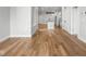Open living space with hardwood floors, leading into a modern kitchen with island and stainless appliances at 319 E 16Th St # 302, Indianapolis, IN 46202